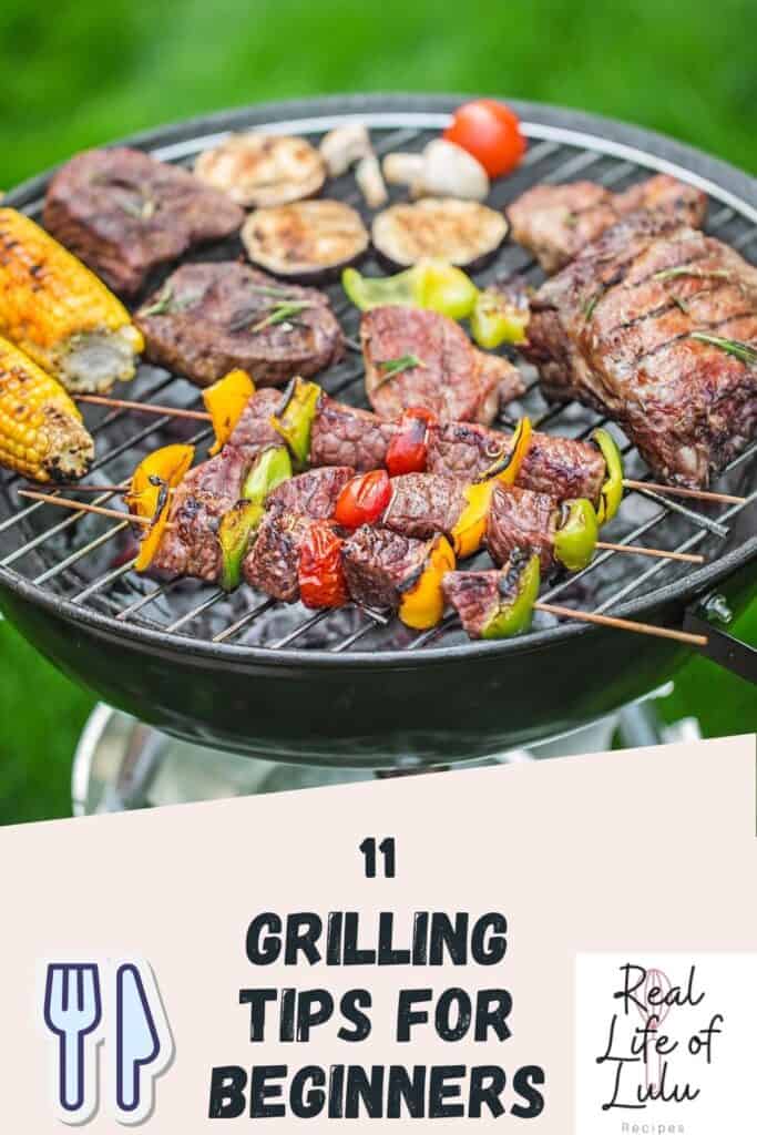A round charcoal grill with steak, corn, vegetable skewers, and mushrooms cooking on it; text below reads 11 Grilling Tips for Beginners with utensil and Real Life of Lulu logos.