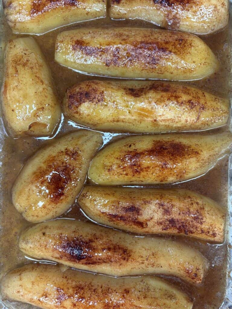 Peeled, cooked sweet potatoes in a glaze sprinkled with cinnamon.
